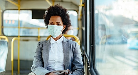 Woman wearing a mask whilst seated on the bus